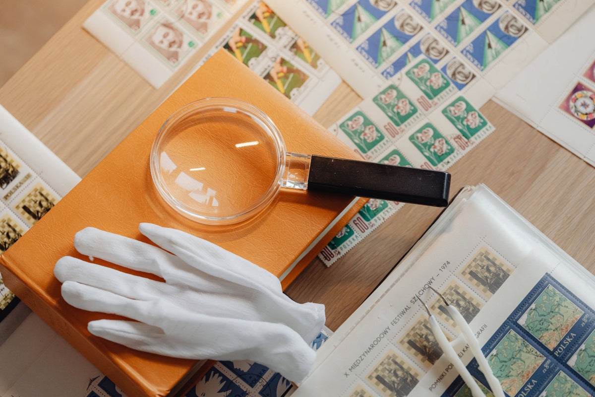 Close-up of an inherited stamp collection being sorted by hand