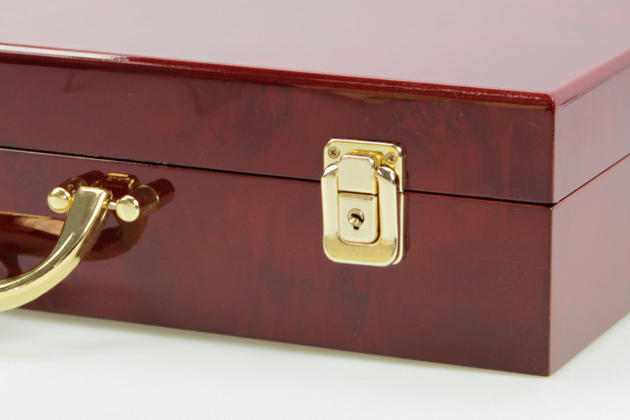 Detail image of the gold handle and snap lock on the burlwood coin case on a white background
