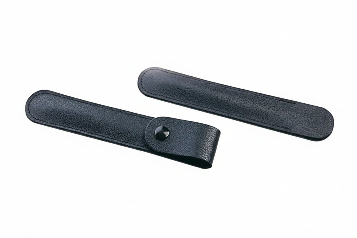 Two black leather ton cases (one with flap enclosure and snap, and one without) on a white background