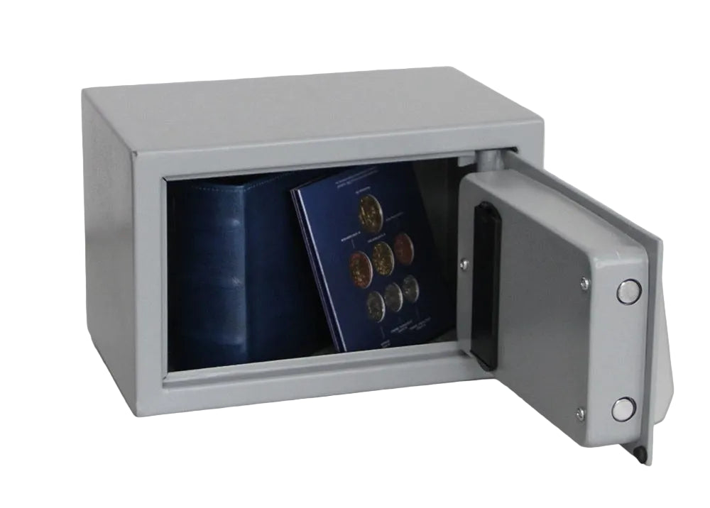 Metal safe with open door revealing coins and an album inside on a white background