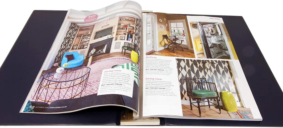 Open collector album with interior design magazine on a white background