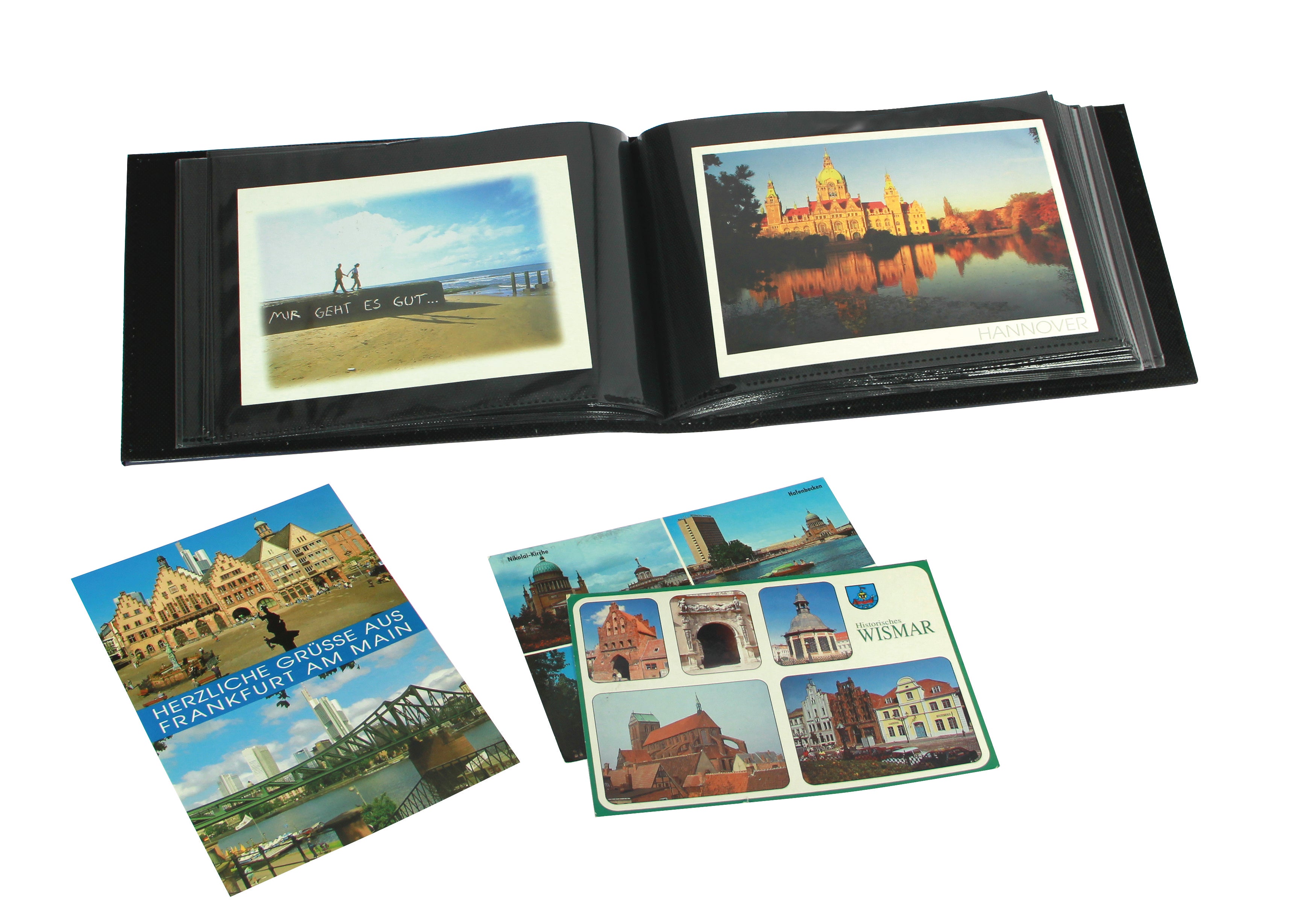 Open postcard album with scenic images and a collection of postcards featuring various landmarks.