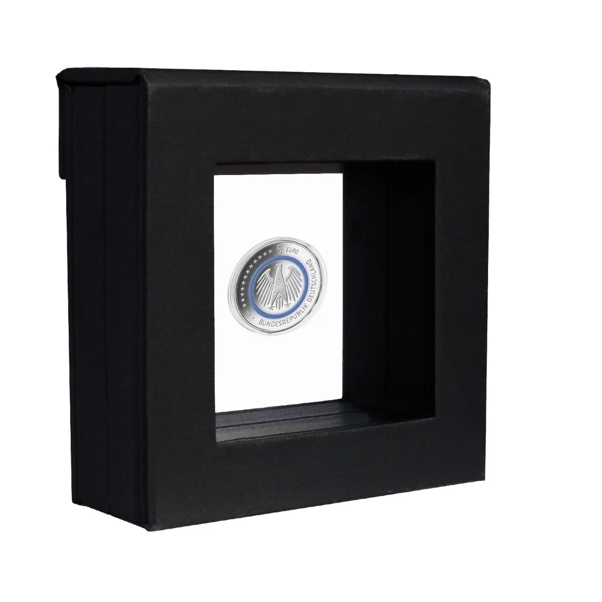 Black square frame with transparent window made of film that is molded to a silver coin in a capsule on a white background