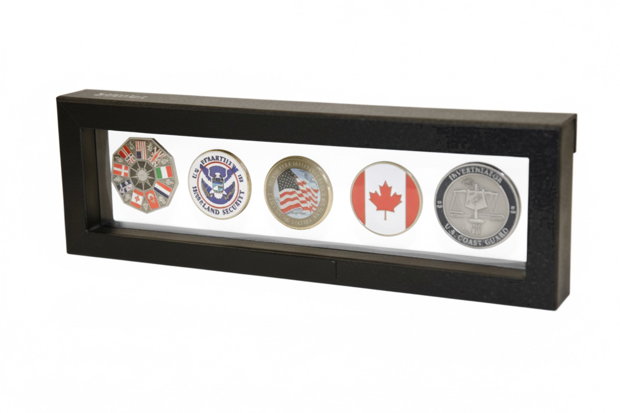 Black rectangular frame/shadowbox with transparent window made of film that is molded to a collection of collectible coins on a white background