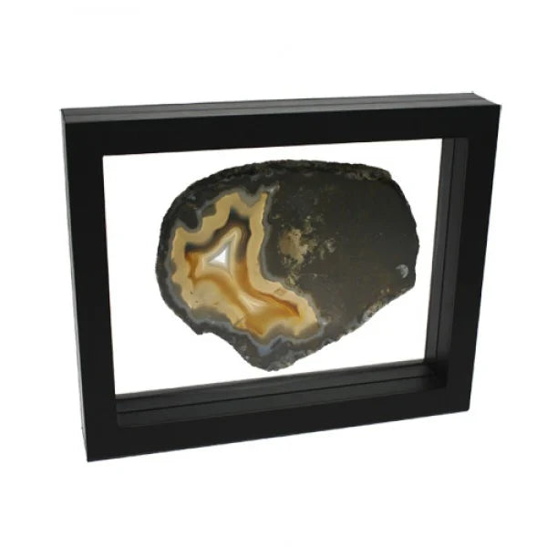 Black square frame/shadowbox with transparent window made of film that is molded to an agate slice on a white background