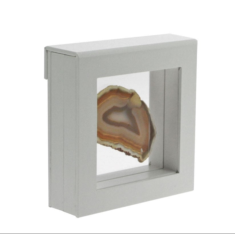 White square frame/shadowbox with transparent window made of film that is molded to an agate slice on a white background