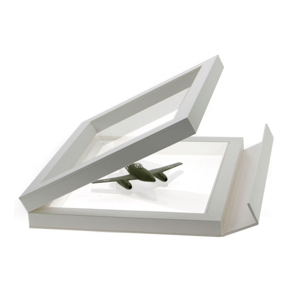 Open white square frame/shadowbox with transparent window made of film that will be molded to a model airplane once closed on a white background