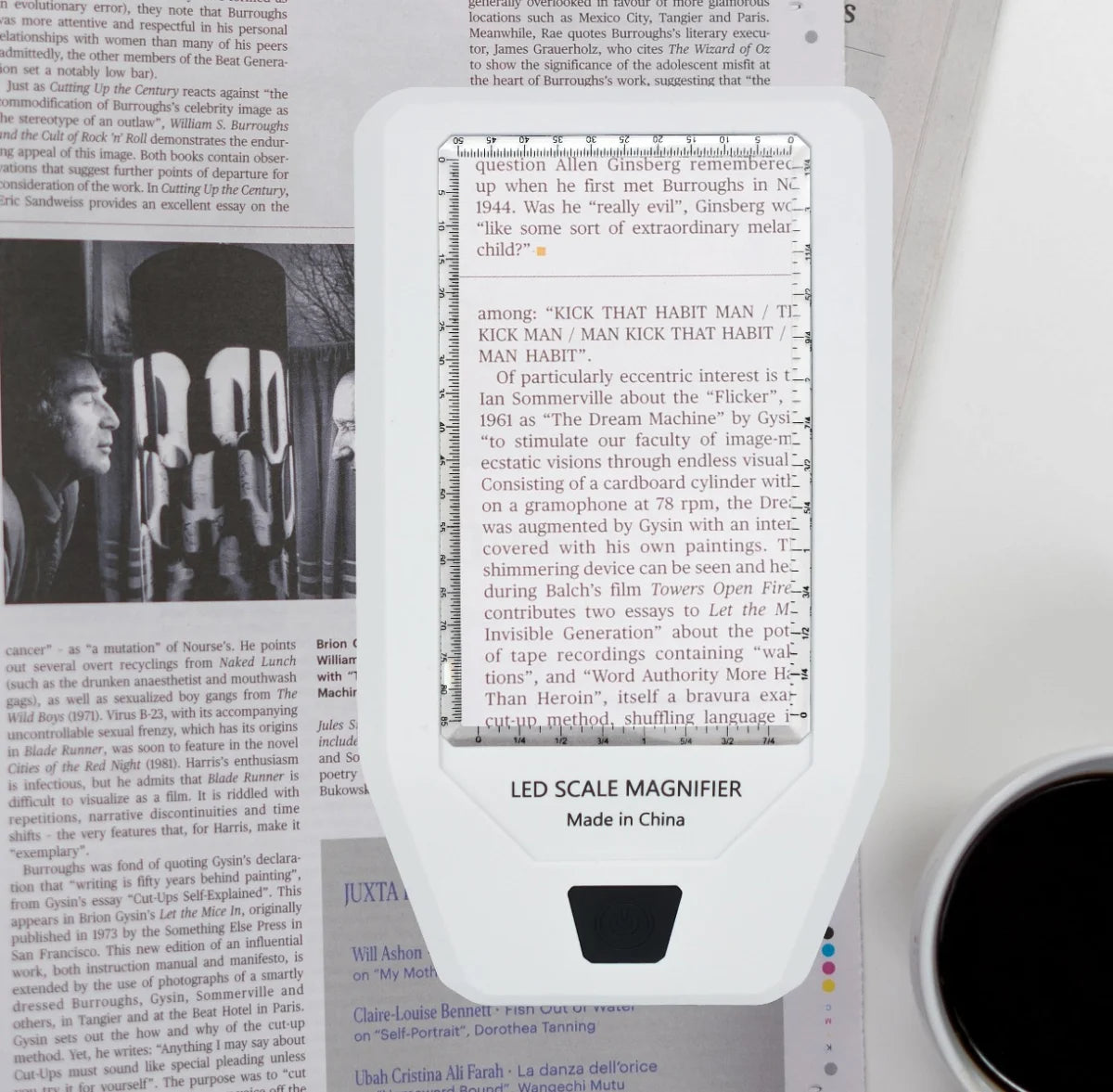 White LED scale / ruler magnifier illuminating and magnifying a newspaper