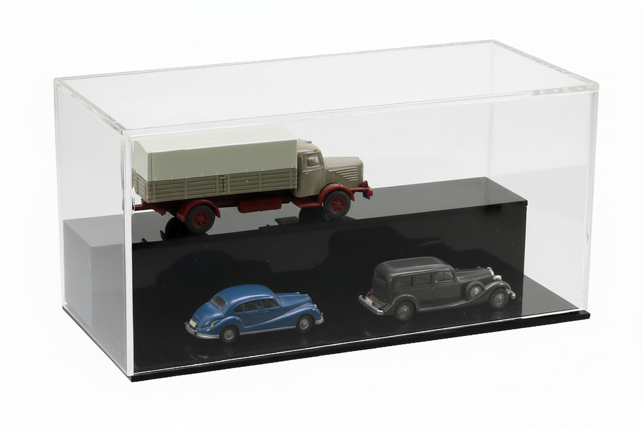 Acrylic display case with a black high glass step and toy model cars displayed in a tiered presentation on a white background