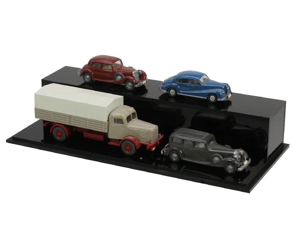 Black high glass steps with toy model cars for a tiered presentation on a white background
