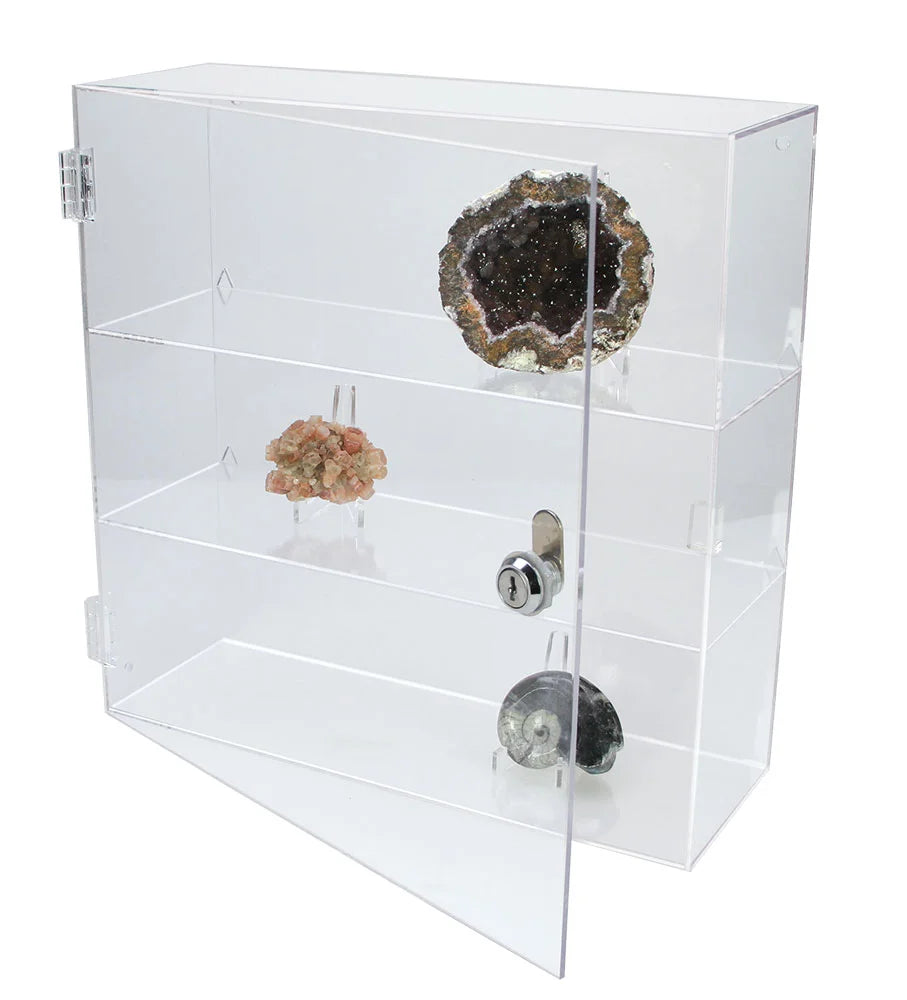 Clear acrylic display curio with multiple shelves holding a collection of rocks, minerals & geodes on a white background