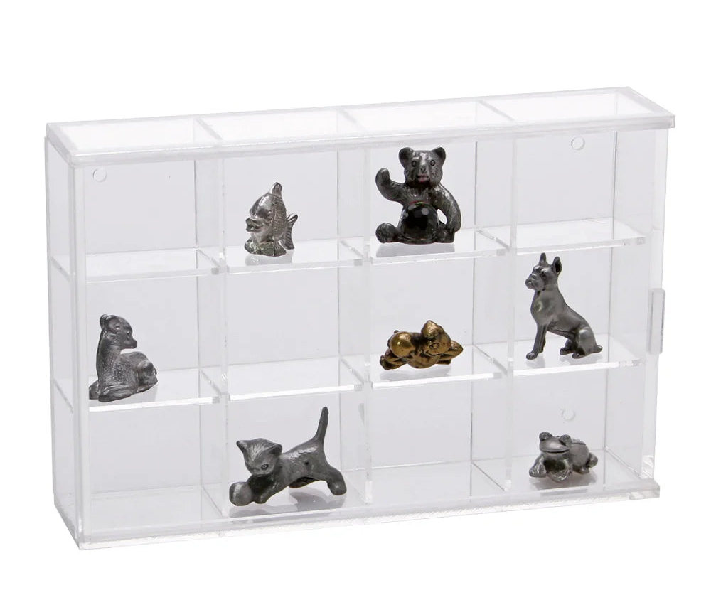 Clear acrylic display case with 12 compartments filled with various collectible mini figurines on a white background