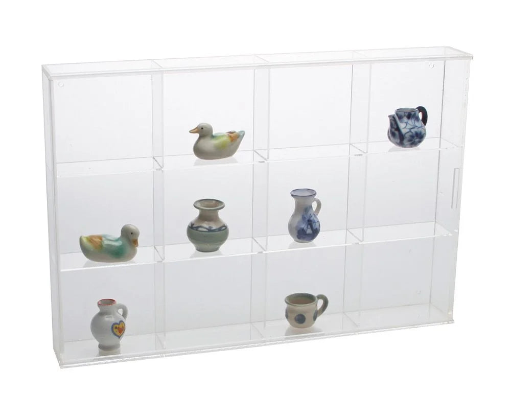 Clear acrylic display case with 12 compartments filled with various small collectible cermaics on a white background