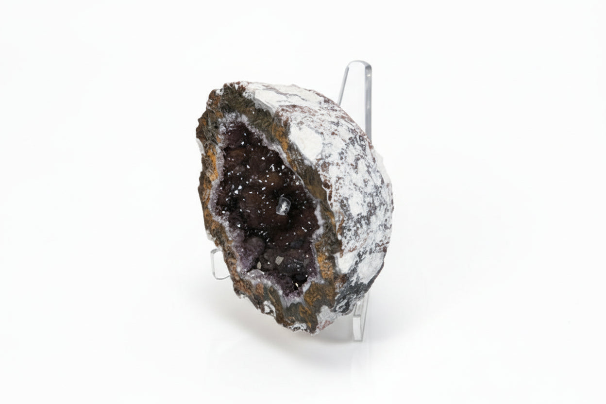 Geode crystal on a acrylic triangular easel/stand against a white background