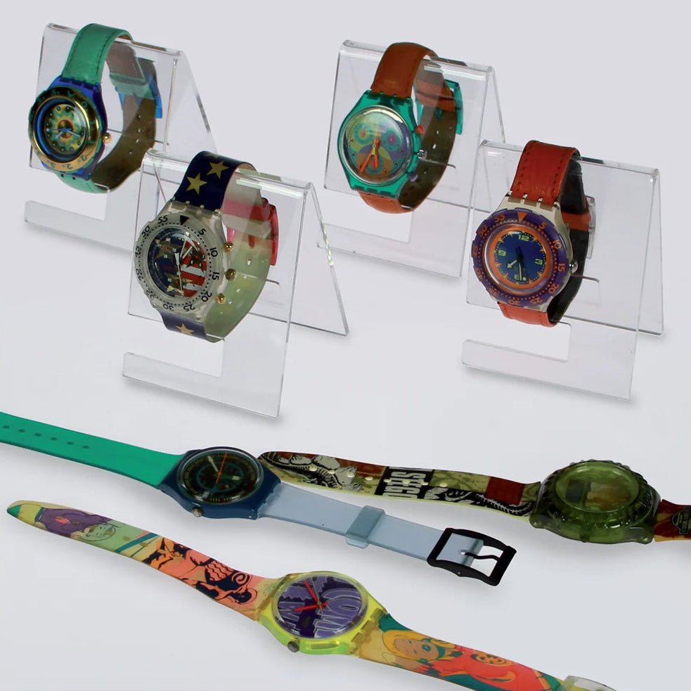 Colorful wrist watches on acrylic watch stands / easels on a white background