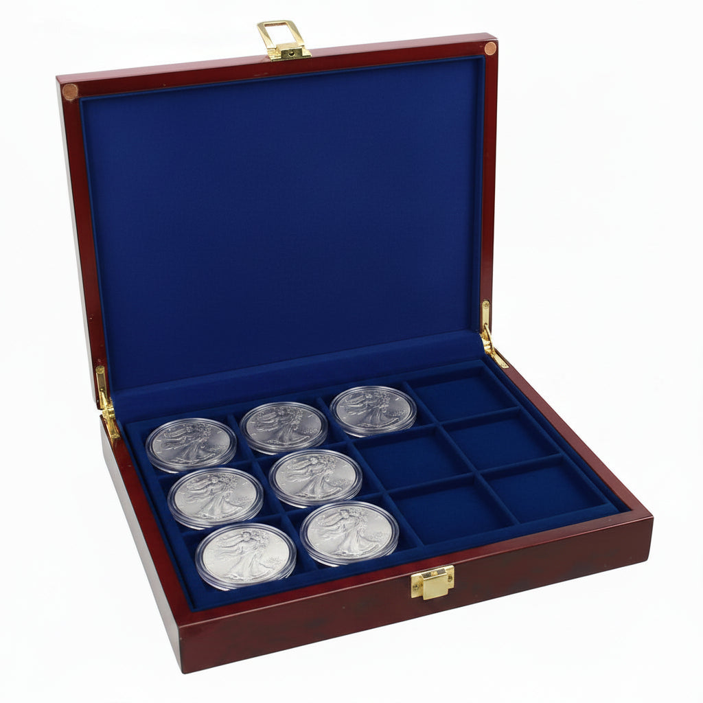 Open burlwood coin collection box with blue velvet trays holding a collection of American Silver Eagles on a white background