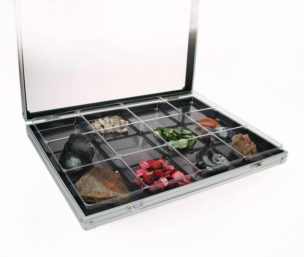 Aluminum display case with 12 compartments filled with minerals & rocks, open with an acrylic lid on a white background