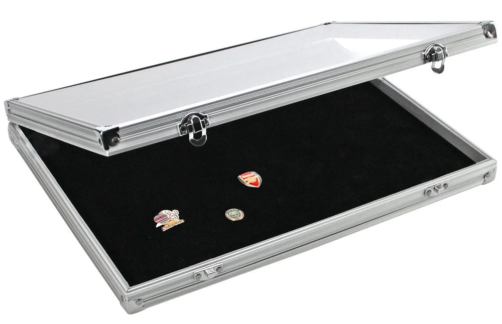 Aluminum display case with black velvet interior holding a pin collection and an open acrylic lid on a white background