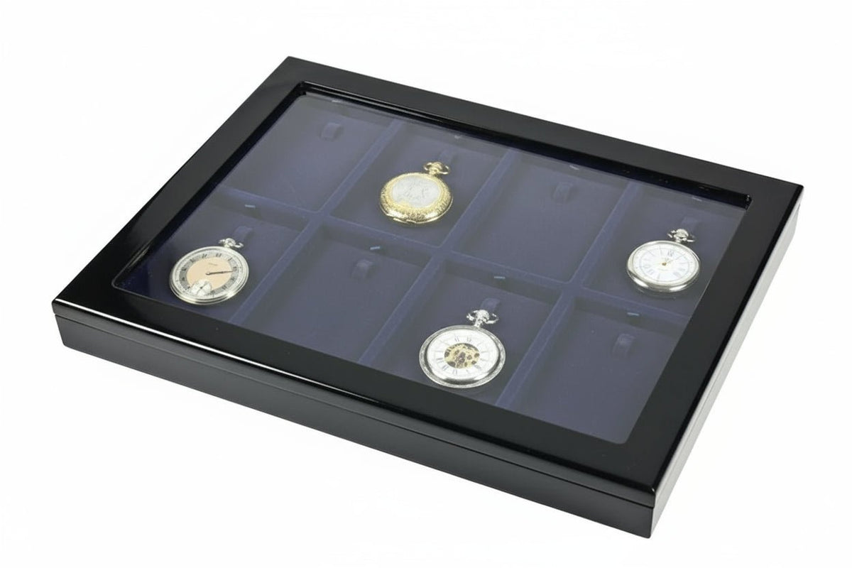 Antique pocket watches on a blue velvet tray inside of a black wooden high gloss display case with the acrylic glass lid (closed) on a white background