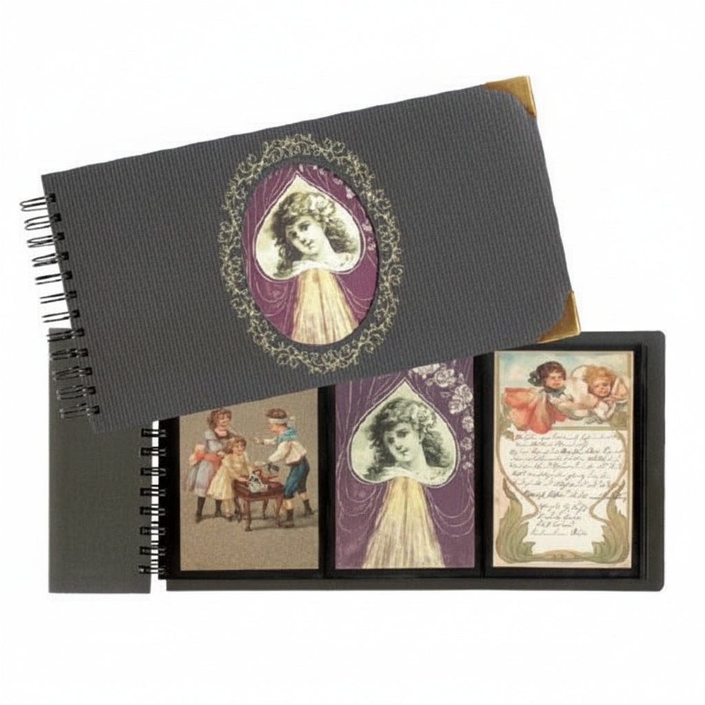 Black spiral-bound postcard album with interchangeable vintage-style illustration on cover, on top of the same postcard album laid open displaying vintage postcards on a white background.