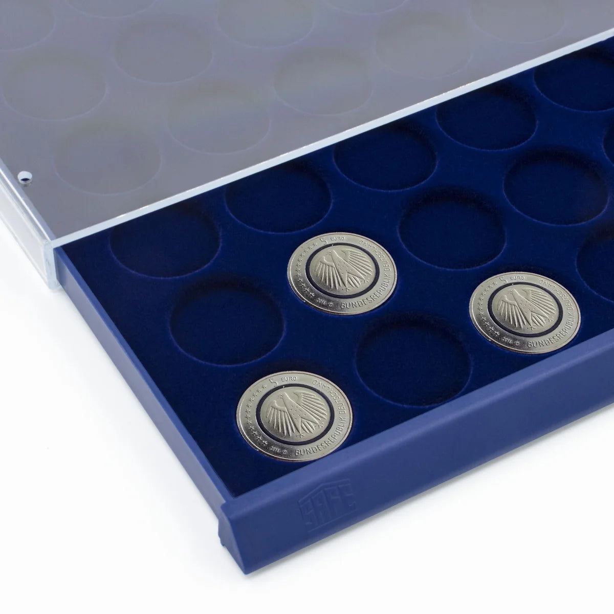 Detail image of open acrylic stackable drawer unit with a blue velvet tray and circular compartments with coins on a white background