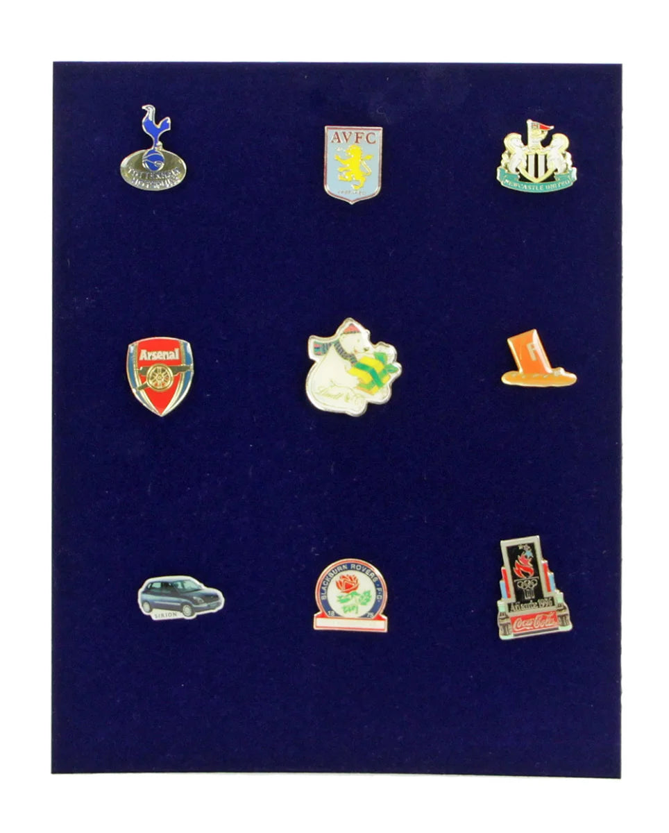 Navy blue velvet foam tray insert with a collection of pins on a white background