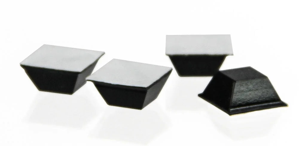 Four black coin case self-adhesive feet on a white background