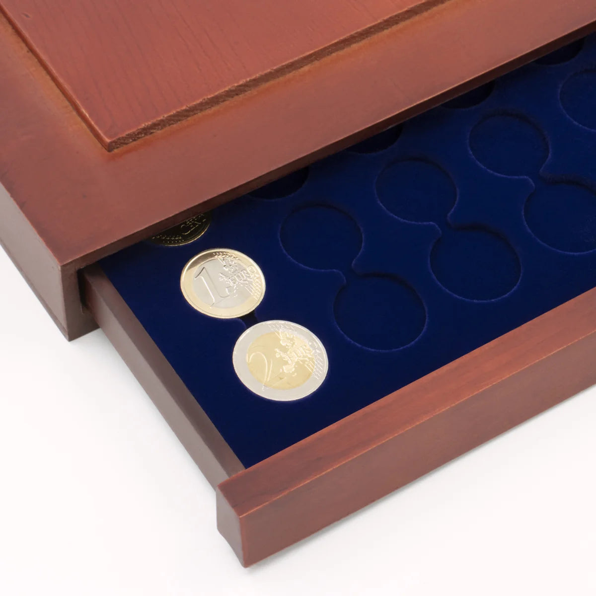 Detail shot of open wooden stackable drawer unit with a blue velvet tray for euro coin sets on a white background