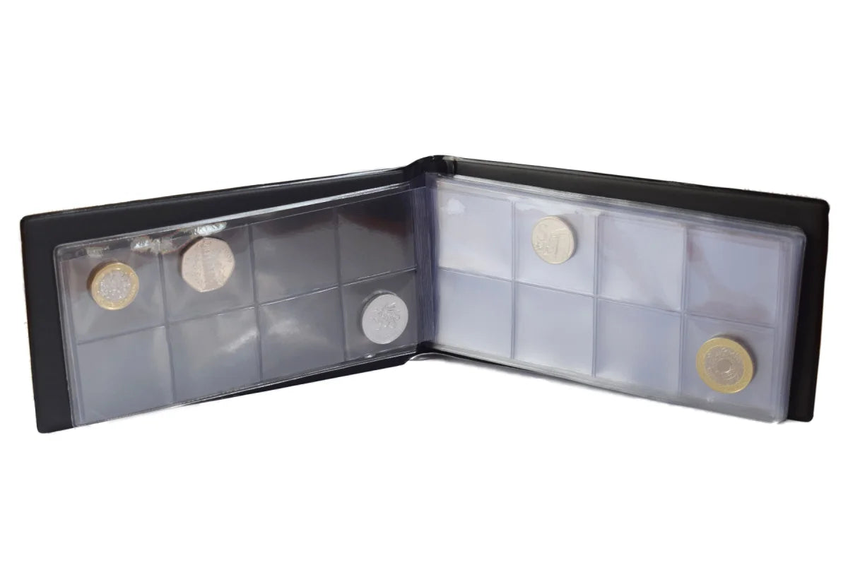 Small black coin album, laid open with coins on a white background