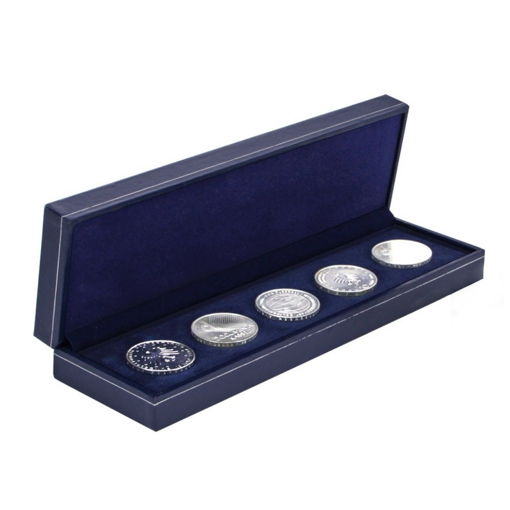 5 silver coins in a navy blue box laying on the blue velvet impressionable foam with a blue lining and the lid open on a white background