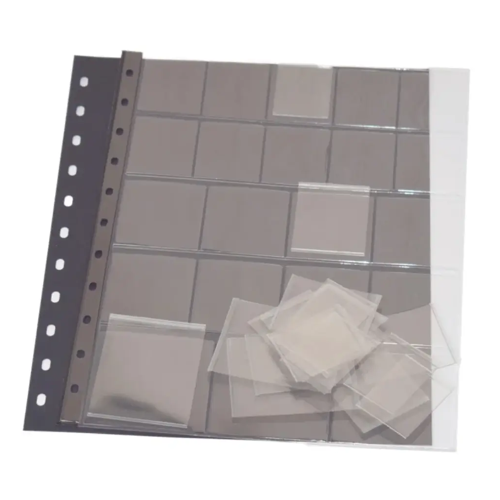 Clear polyester page with multiple compartments and each compartment has an individual removable pocket with a black interleaf on a white background