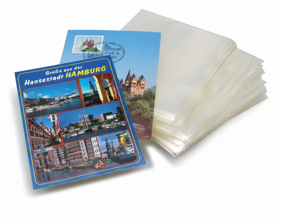 Travel postcards with Hamburg-themed design and a stack of transparent protective sleeves.
