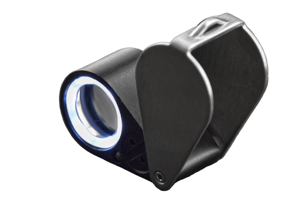 Handheld loupe magnifier with UV/LED ring light turned on, on a white background