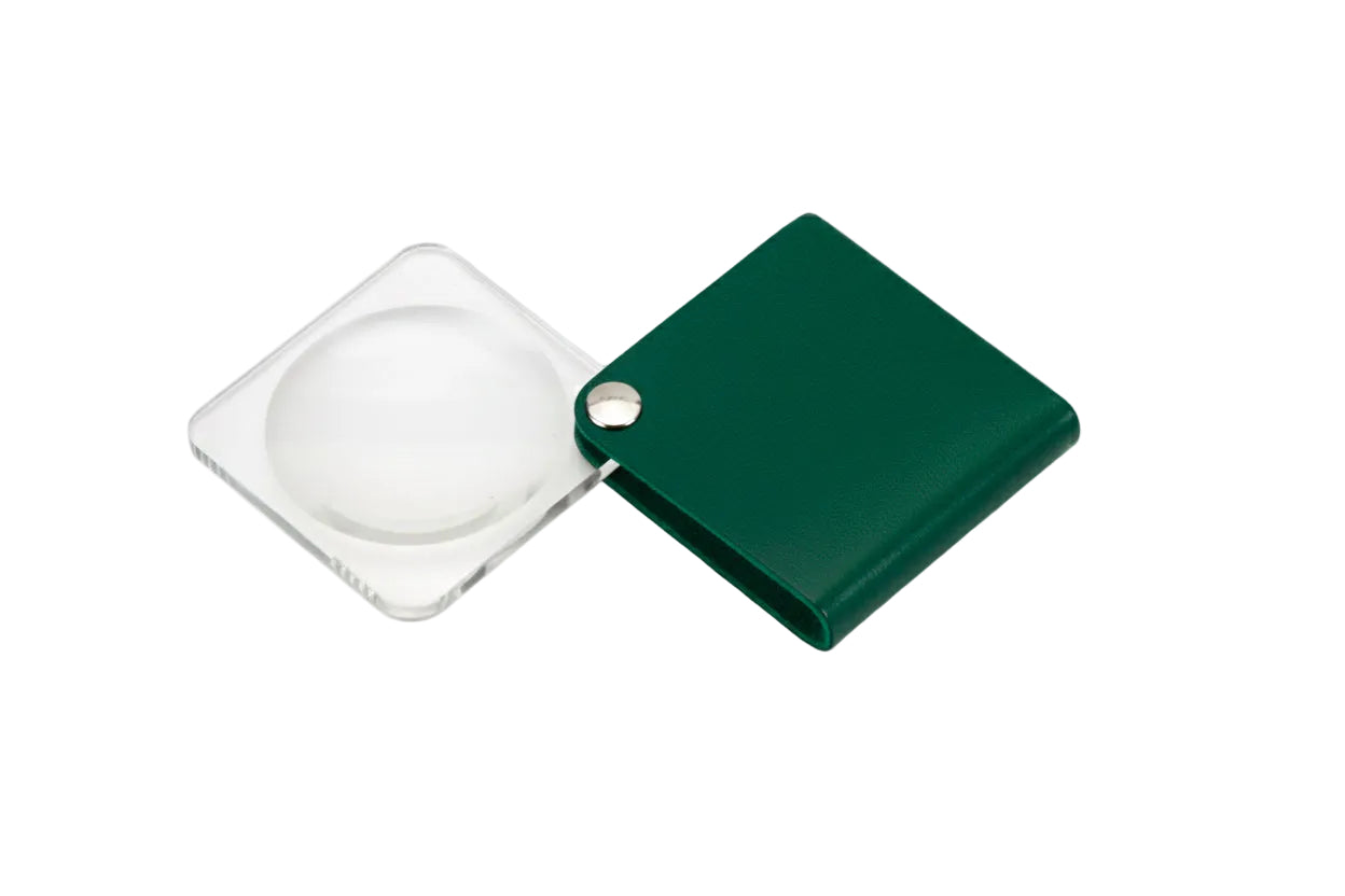 Slide out magnifier inside a green square case on a white background