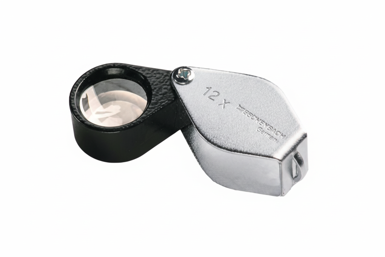 12x Magnifying glass loupe with a black body and silver handle on a white background