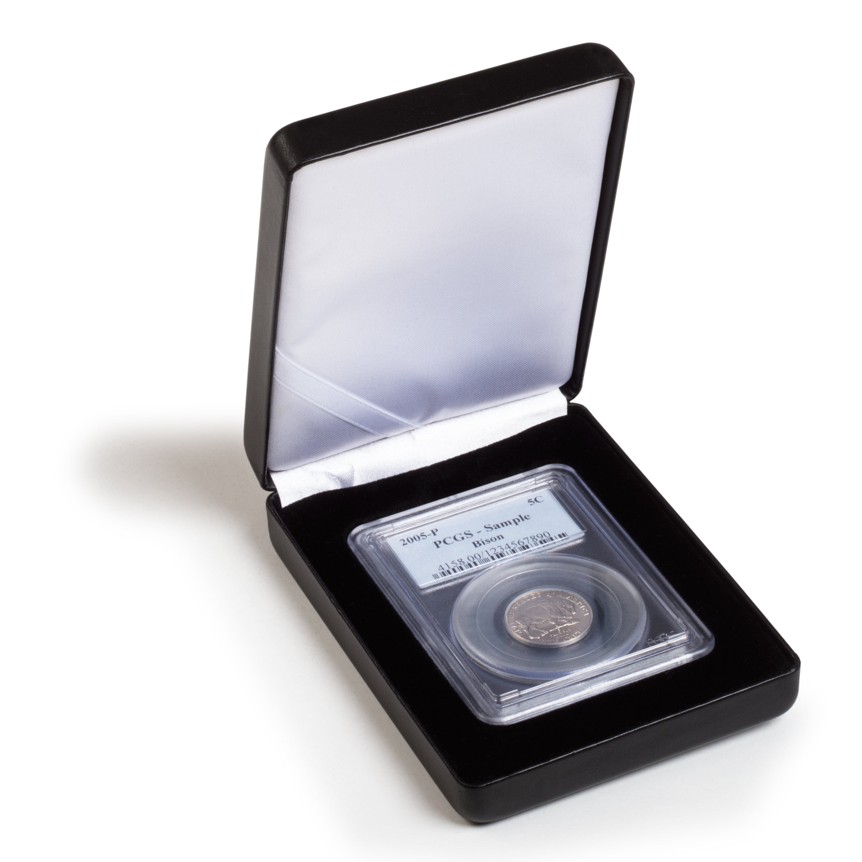 Open black coin case with a white silky interior displaying a single graded coin slab on a black insert on a white background