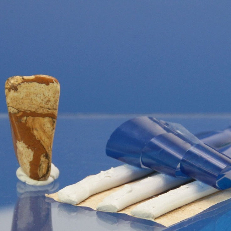 Off-white museum mounting putty strips for minerals and collectible displays