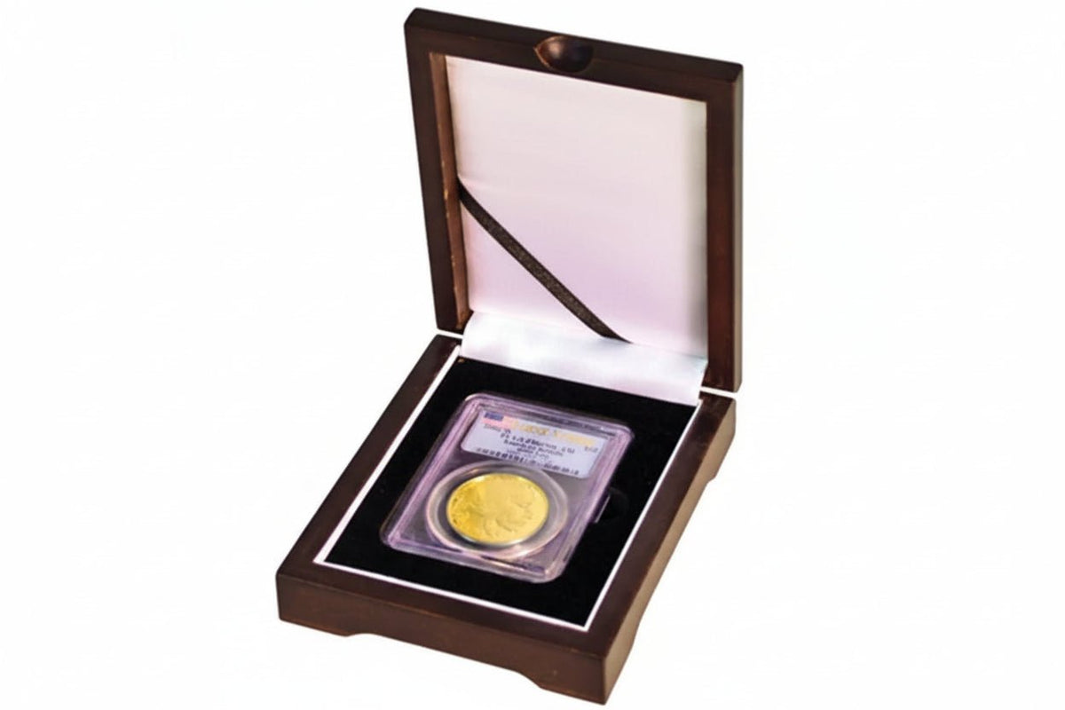 Gold graded coin slab in a wooden display case with a white background
