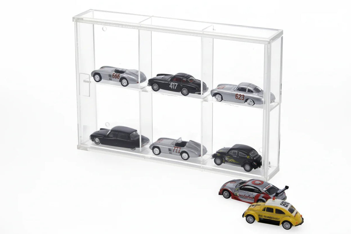 Collection of model cars displayed in a clear acrylic case on a white background