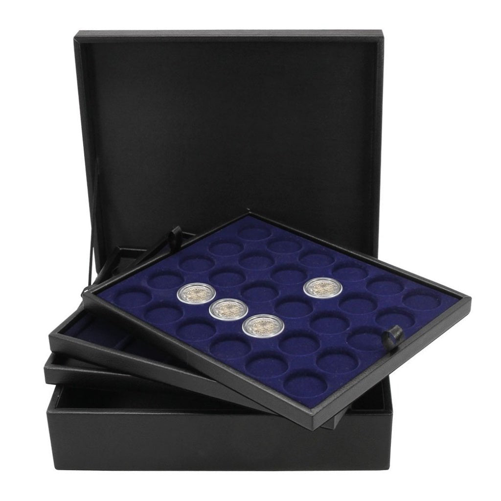 Collection of coins on a blue velvet tray stacked on top of other trays on an open black leather display case, on a white background.