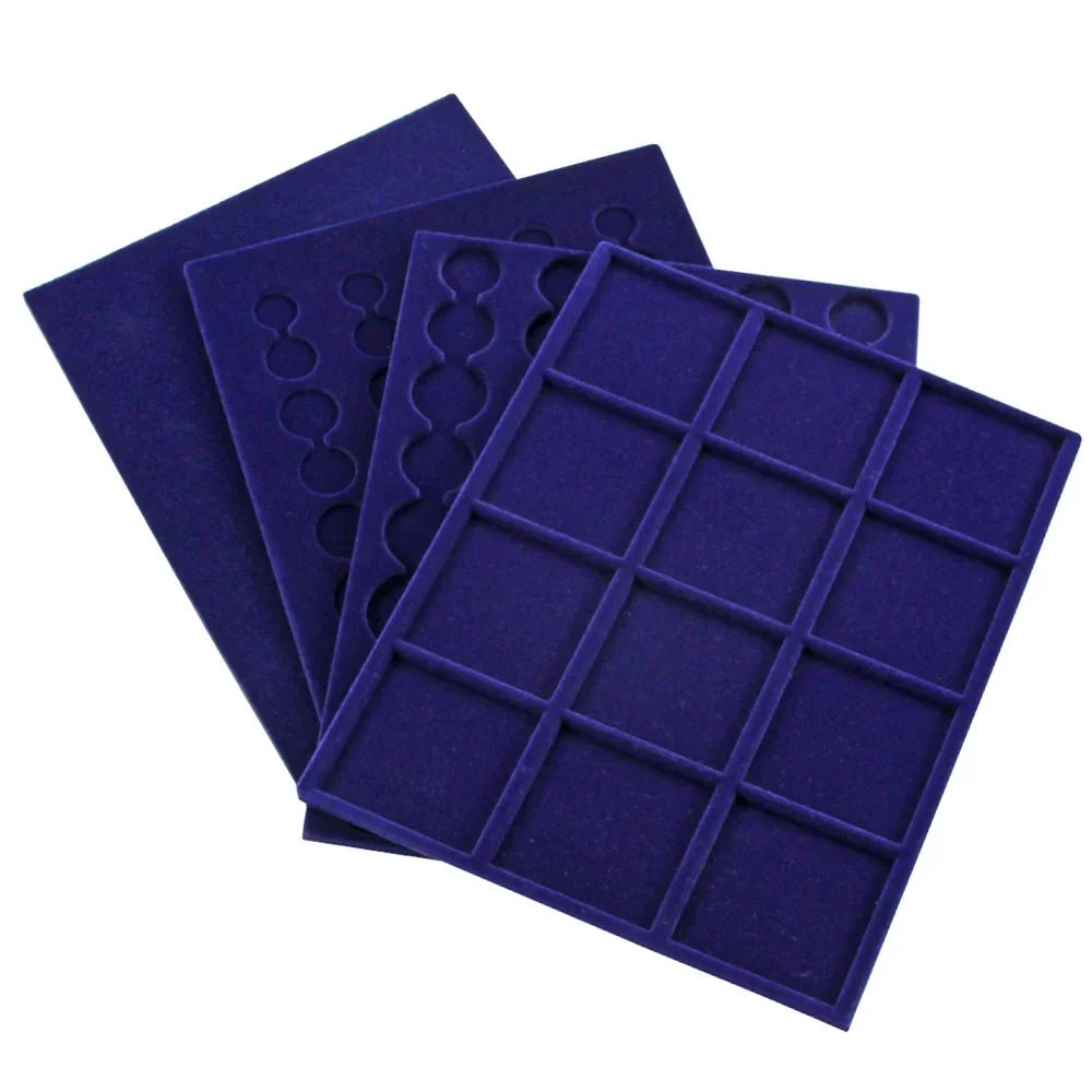 Set of blue velvet coin trays with round & square compartments spread out on a white background