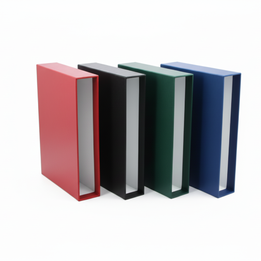 Four empty album slipcases in red, black, green, and blue on a white background