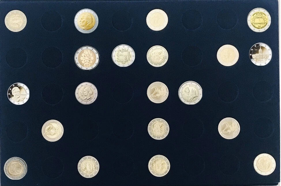 A collection of assorted coins displayed in a blue velvet coin tray, photographed from above against a plain white background.