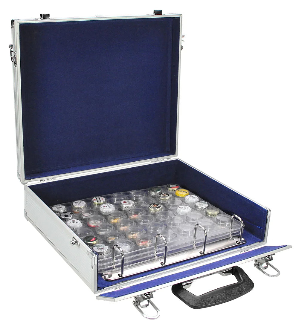 Open briefcase with 4 ring binder mechanism holding pages with compartments containing various small bottle caps on a white background