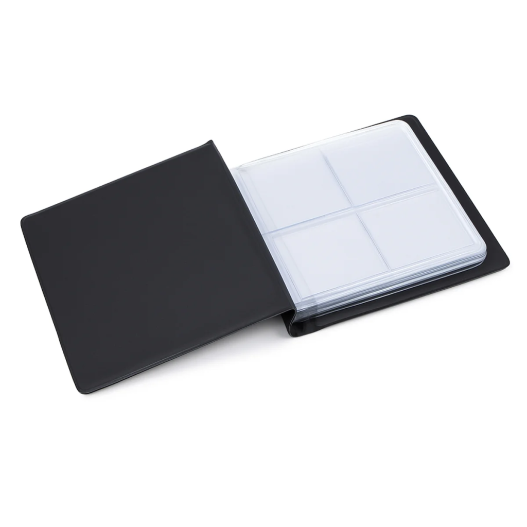 An open black pocket-sized coin album with transparent pages and pockets on a white background