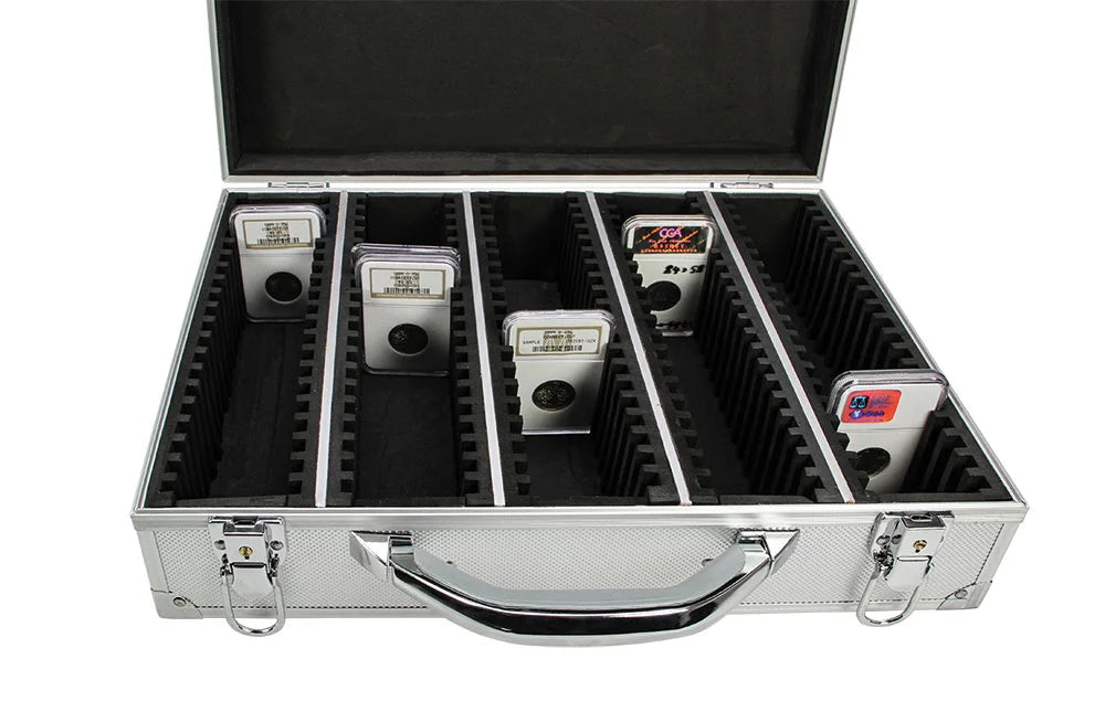 Open aluminum coin case with 100 individual foam compartments holding graded slabs, on a white background