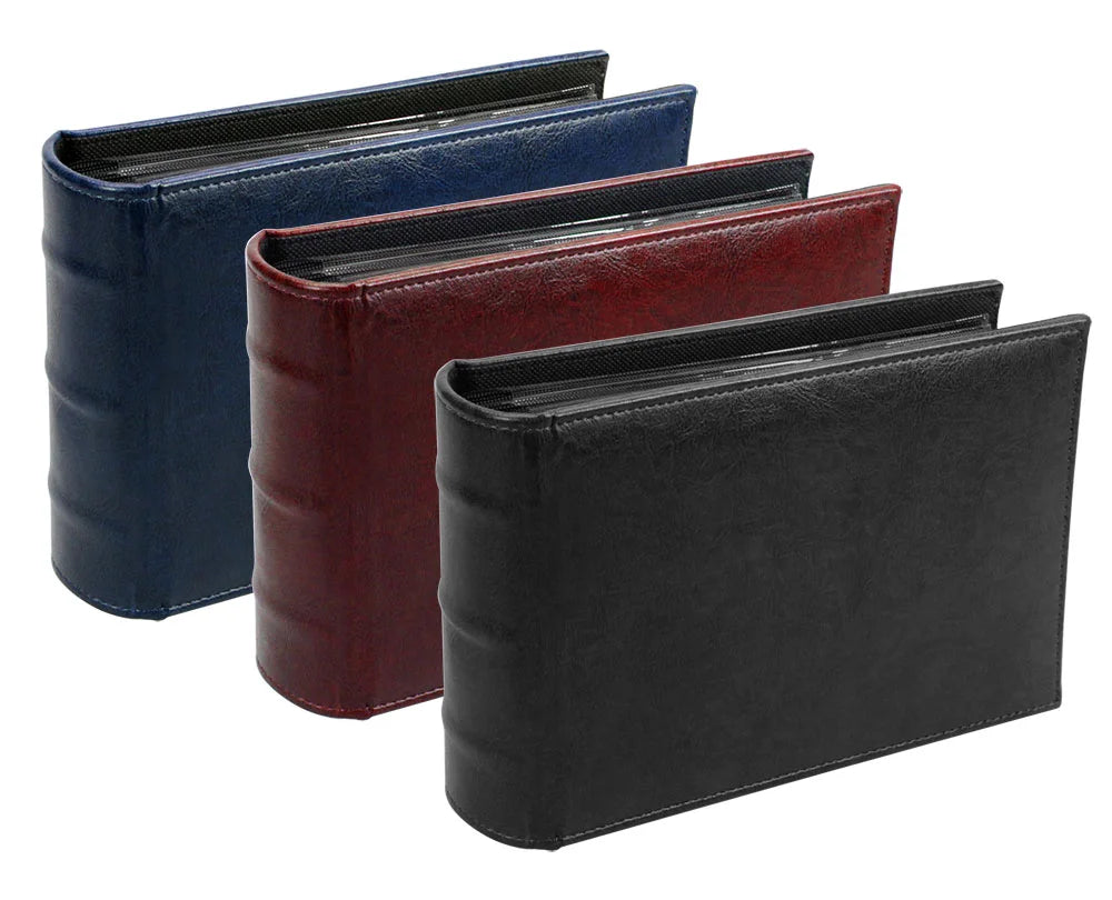 Three wide-spine collector albums in black, red, and blue on a white background