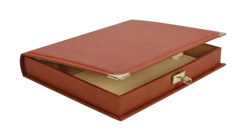 Saddle tan binder that acts as a built in slipcase, slightly ajar, with gold accents and lock/key on a white background