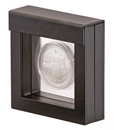 Black square frame with transparent window made of film that is molded to a silver coin on a white background