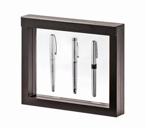 Black square frame/shadowbox with transparent window made of film that is molded to a collection of 3 pens on a white background